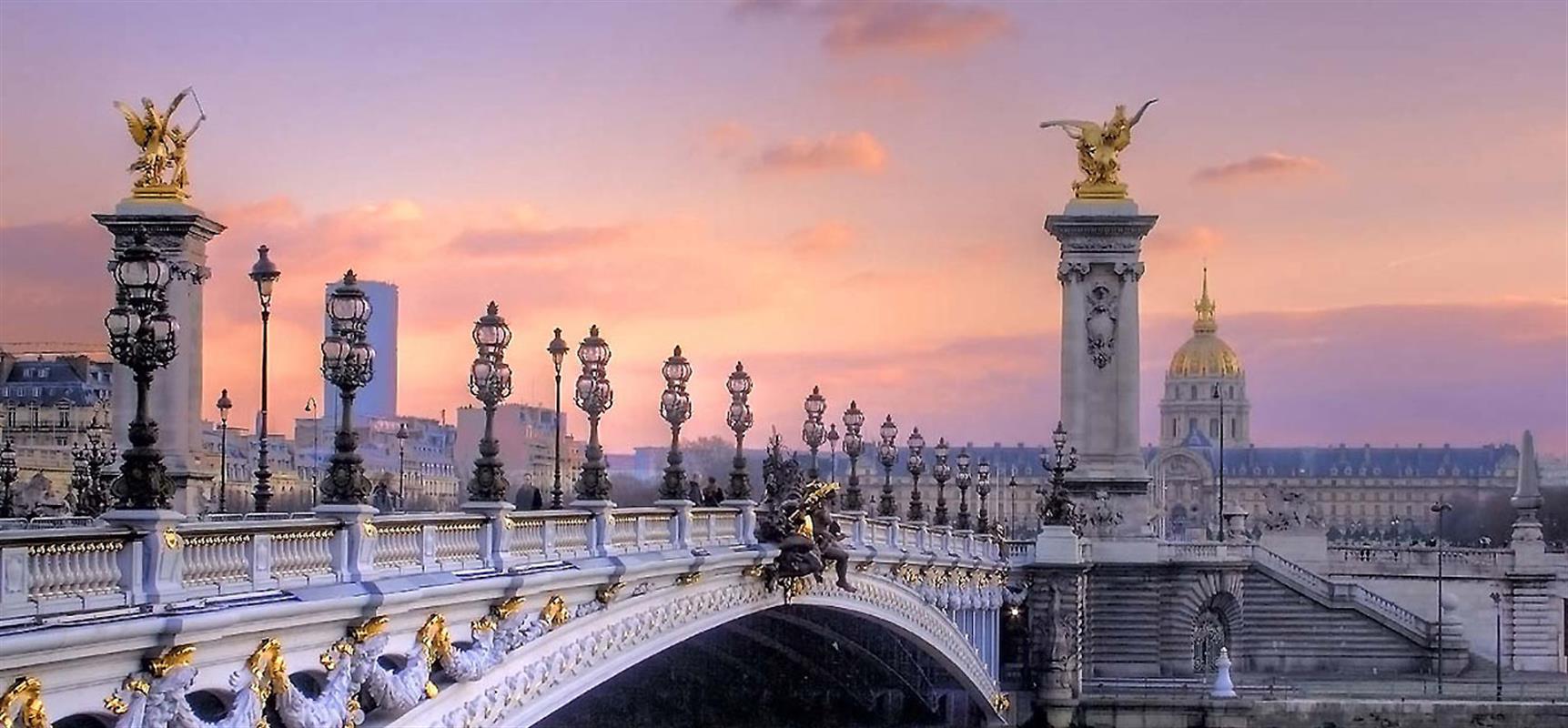 Arched bridge with art nouveau lamps along the Seine River in Paris, France